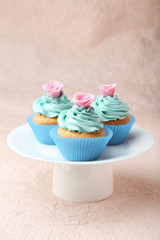 Tasty cupcake on pink background