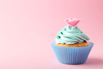 Tasty cupcake on pink background