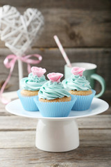 Tasty cupcake on grey wooden background