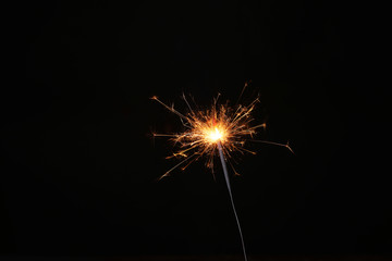 New year party sparkler on black background