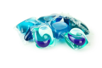 Gel capsules with laundry detergent on a white background