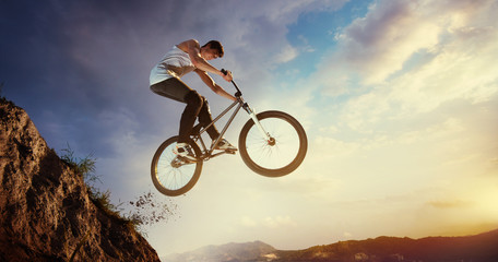 Fototapeta na wymiar Sport. Biker jumps