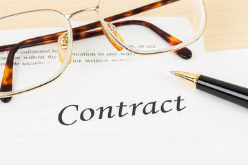 Business contract with pen and glasses; contract and information