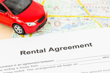 Car rental agreement on map; document is mock-up