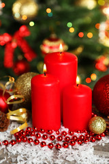 Christmas balls and candles on grey wooden background