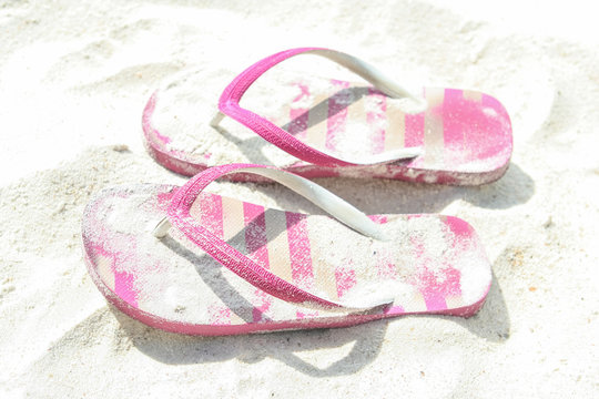 Pair of pink striped sandal on white background