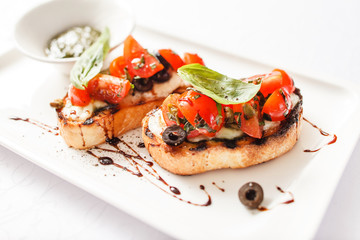 Bruschetta with tomato, mozarella and basil