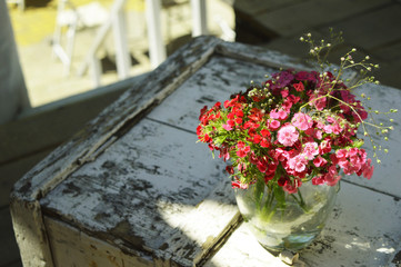 Flowers in a vase on an old table