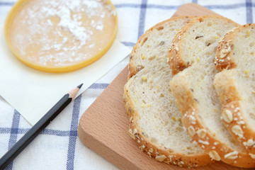 Sliced white bread on wooden plate