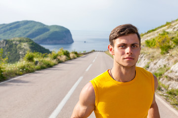 Healthy active man runner running on the road