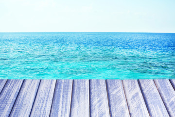 Wooden pier with blue sea and sky background