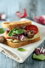 Tasty sandwich on wooden table, close up