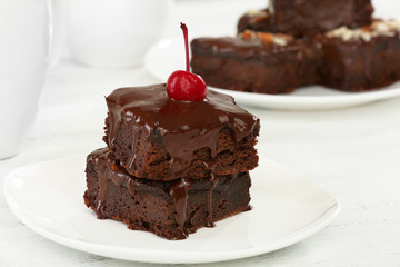 Delicious chocolate cakes on plate on table close-up