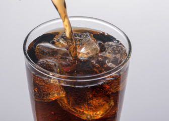 Refreshing Brown Soda with Ice on a background
