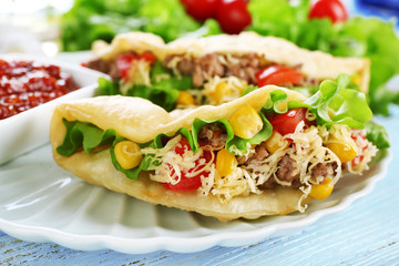 Tasty taco on plate close up