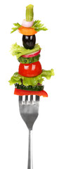 Different vegetables on fork isolated on white