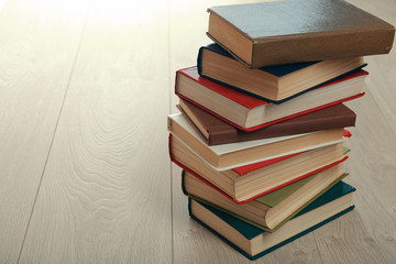 Stack of books on wooden background