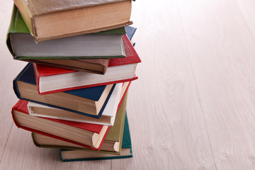 Stack of books on wooden background