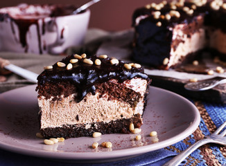Delicious chocolate cake with icing in plate on table, closeup