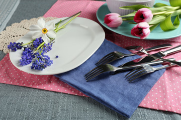 Tableware with flowers on table close up