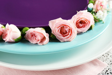 Tableware with flowers on table close up