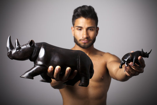Hombre sopesando rinoceronte grande y peque&ntilde;o