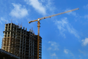 High-rise building under construction and crane
