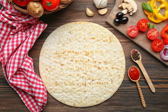 Ingredients for cooking pizza on wooden table, top view