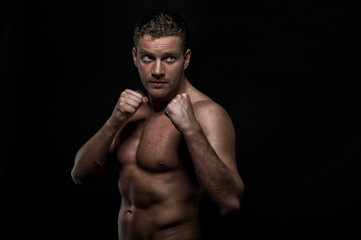 Fototapeta premium strong handsom man on black background