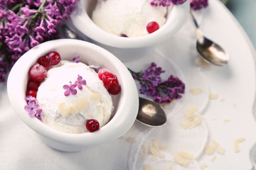 Beautiful composition with tasty ice cream and lilac flowers