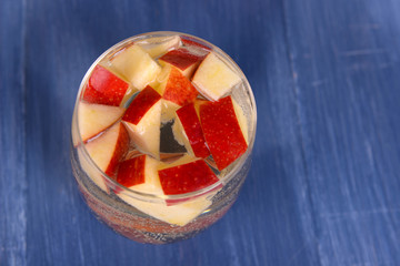 Glass of apple cider on wooden background