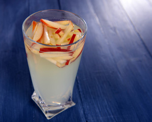 Glass of apple cider on wooden background