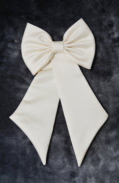 white bow on the bride's wedding dress on a dark background
