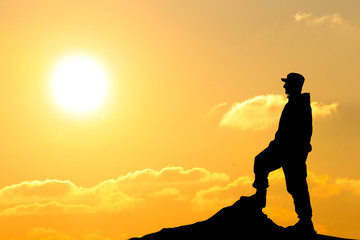 Silhouette of soldier with rifle against a sunset