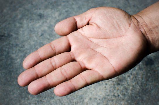 Hand of young man on gray background / Close up image