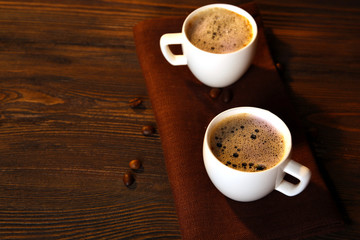 Cups of coffee on napkin on table close up