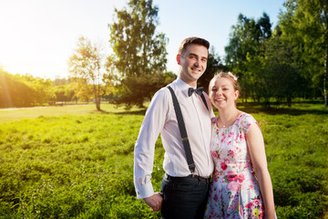 Young happy couple in love portrait in summer park
