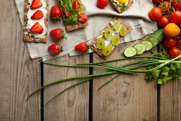 Still life with vegetarian sandwiches on wooden table