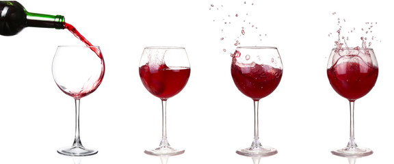 Red wine pouring from bottle into big glass on white background