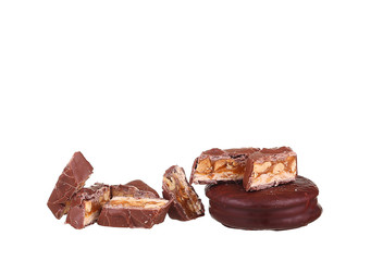 Tasty chocolate bar split in two pieces. Delicious caramel cream and peanuts inside.White background.