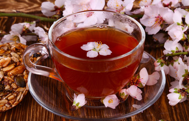 tea and a branch of cherry blossoms on a wooden