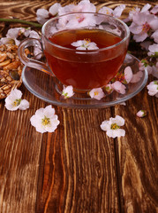 tea and a branch of cherry blossoms on a wooden