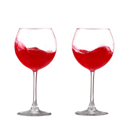 red wine splashing in a glass, isolated on white