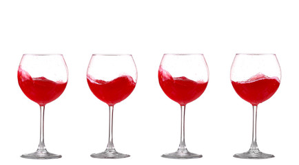 red wine splashing in a glass, isolated on white