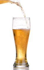 Pouring beer from bottle isolated on white background