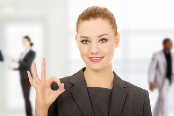 Business woman showing perfect hand sign.