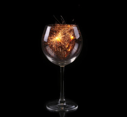 Wine glass with a sparkler. In anticipation of New Year and Christmas