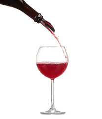 red wine pouring into wine glass isolated