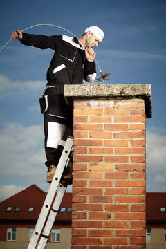 Man cleaning chimney