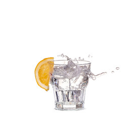 Ice cubes splashing into glass of water, isolated on white
